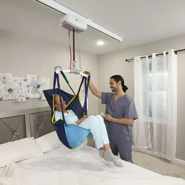 male caretaker assisting female patient in a sling ceiling lift