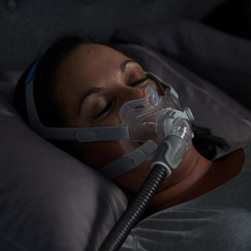 woman sleeping with a full face mask cpap